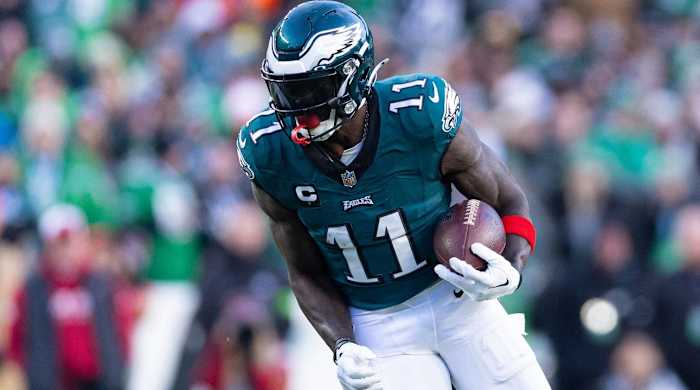 Philadelphia Eagles wide receiver A.J. Brown runs with a ball in a game.